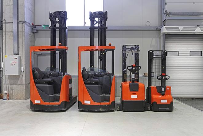 forklifts stacking materials in a warehouse